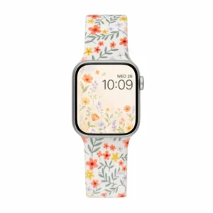 White silicone apple watch band for women with small yellow orange and grey floral pattern and metal buckle.