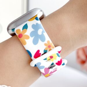 White silicone Apple Watch band with colorful pink blue and yellow retro flower pattern.