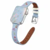 Light blue denim style vegan leather apple watch strap for women with embroidered cherries and pink bows.