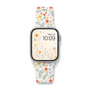 White silicone apple watch band for women with small yellow orange and grey floral pattern and metal buckle.