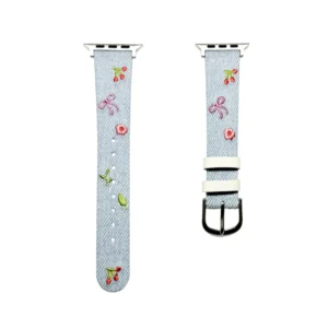 Light blue denim style vegan leather apple watch strap for women with embroidered cherries and pink bows.