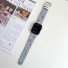 Light blue denim style vegan leather apple watch strap for women with embroidered cherries and pink bows.