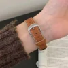 Pumpkin brown Vegan PU Leather Apple Watch Strap with white stitching and slim tapered design.