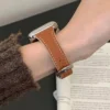 Pumpkin brown Vegan PU Leather Apple Watch Strap with white stitching and slim tapered design.