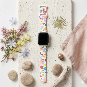 White silicone Apple Watch band with colorful pink blue and yellow retro flower pattern.