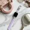 Lilac purple leather Apple Watch band for women with a silver metal heart charm.