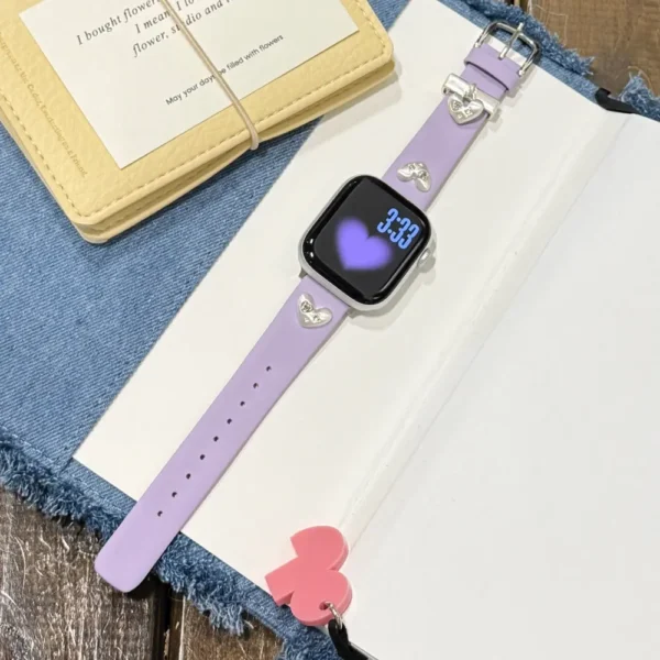 Lilac purple leather Apple Watch band for women with a silver metal heart charm.