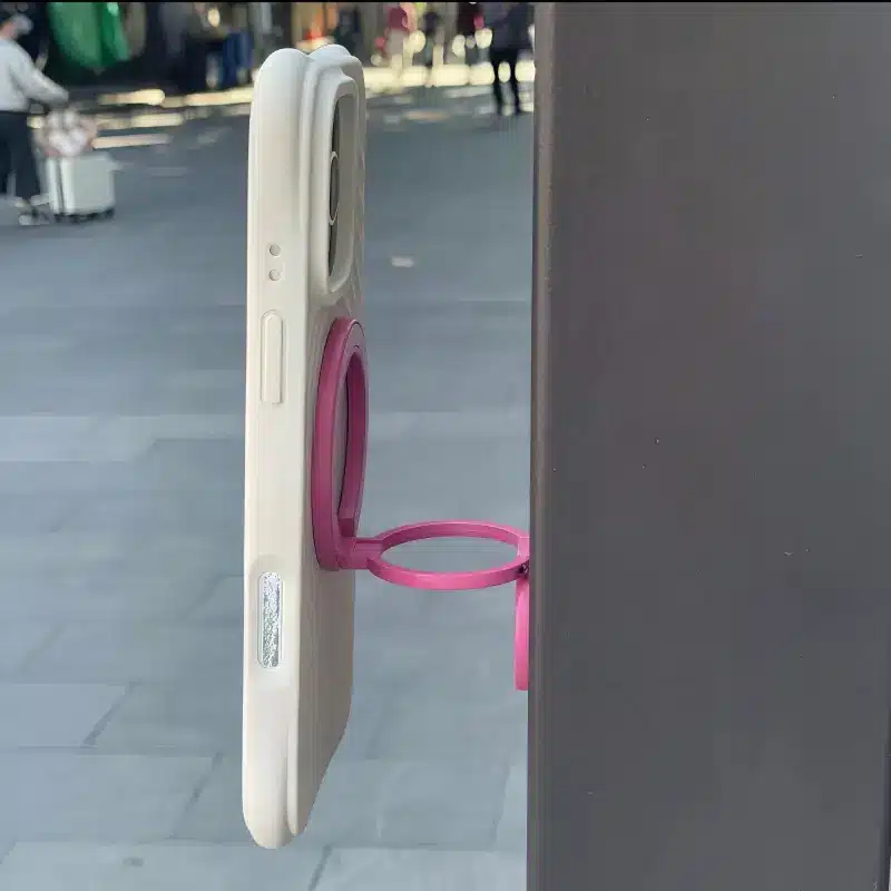 Rose Magenta foldable MagSafe stand for iPhone, adjustable multi-angle magnetic phone holder for desk and video calls.