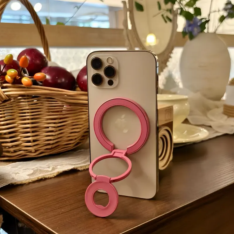Rose Magenta foldable MagSafe stand for iPhone, adjustable multi-angle magnetic phone holder for desk and video calls.
