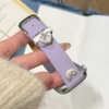 Pretty Lilac purple leather Apple Watch band for women with a silver metal heart charm.