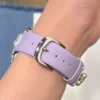 Pretty Lilac purple leather Apple Watch band for women with a silver metal heart charm.