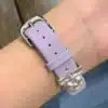 Pretty Lilac purple leather Apple Watch band for women with a silver metal heart charm.