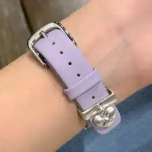 Pretty Lilac purple leather Apple Watch band for women with a silver metal heart charm.