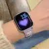 Pretty Lilac purple leather Apple Watch band for women with a silver metal heart charm.