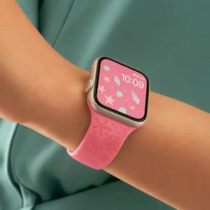 Pink Coral Silicone Apple Watch Strap for women featuring engraved starfish and seashell patterns on a neo pink band.
