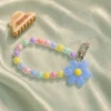 Durable pastel daisy blue beaded phone strap for women featuring a lightweight acrylic bead chain and a silver metal clasp.