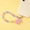Durable pastel daisy pink beaded phone strap for women featuring a lightweight acrylic bead chain and a silver metal clasp.