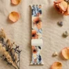 Comfortable braided loop Apple Watch band for women featuring a vintage peach floral pattern on a stretchy replacement strap.