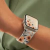 Comfortable braided loop Apple Watch band for women featuring a vintage peach floral pattern on a stretchy replacement strap.