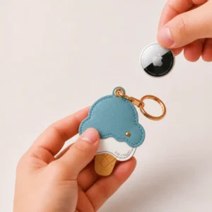 Blueberry ice cream cone vegan leather AirTag case in dusty blue and cream with gold keyring, cute AirTag holder for women