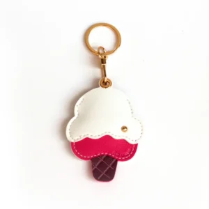 Raspberry ripple ice cream cone vegan leather AirTag case in pink and cream with gold keyring, cute AirTag holder for women