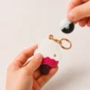 Raspberry ripple ice cream cone vegan leather AirTag case in pink and cream with gold keyring, cute AirTag holder for women