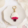 Raspberry ripple ice cream cone vegan leather AirTag case in pink and cream with gold keyring, cute AirTag holder for women