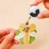 Vegan leather AirTag case in yellow and ivory vintage lily design with gold keyring, cute AirTag holder for women