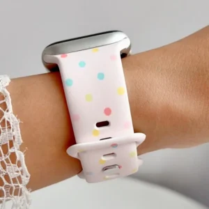Blush pink Apple Watch band for women with pastel rainbow confetti polka dots, soft silicone replacement strap.