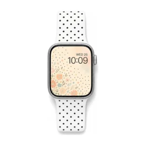 White silicone Apple Watch strap with black polka dots and pin-and-tuck clasp, comfortable replacement band for women