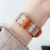Slim coral boucle tweed Apple Watch band for women, comfortable vegan leather replacement strap with woven stripes.