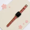 Slim rose tartan tweed Apple Watch band for women, comfortable vegan leather replacement strap in pink check.